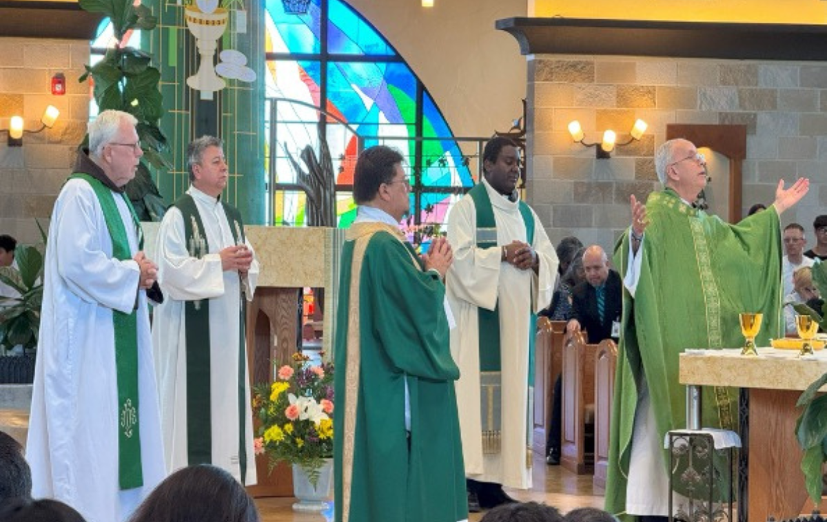 A bishop celebrates a Mass with four concelebrants.