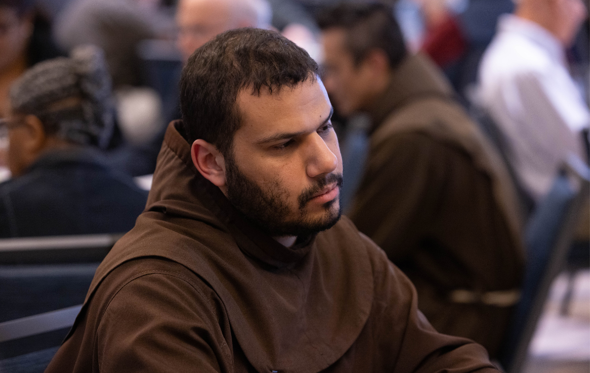 A profile view of a bearded man wearing a brown friar habit.