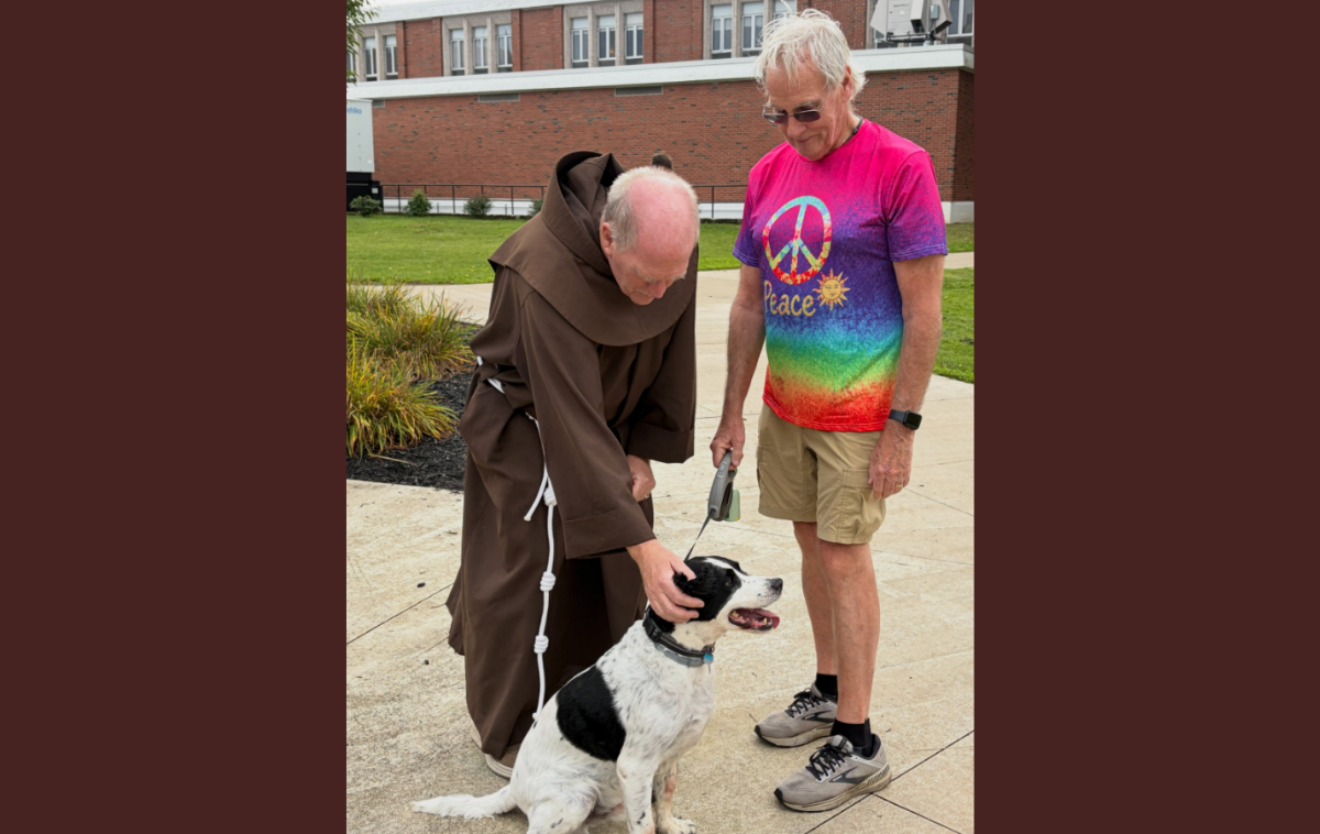 Br. Kevin Kriso, OFM, blesses Parker, with his person, Mike Kelley. (Photo courtesy of St. Bonaventure University)