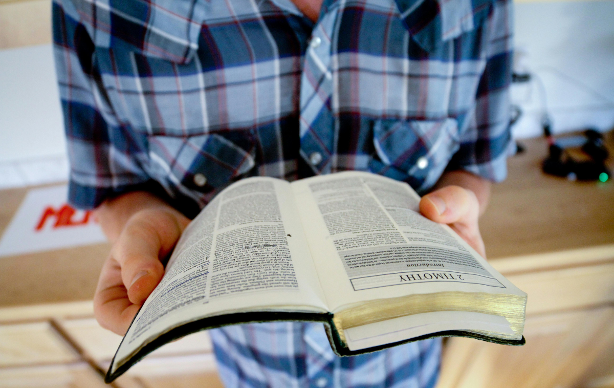 A man holds a Bible in his hands.