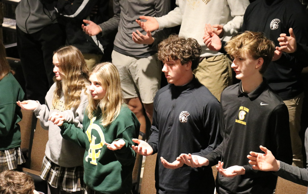 Students pray together during Mass.