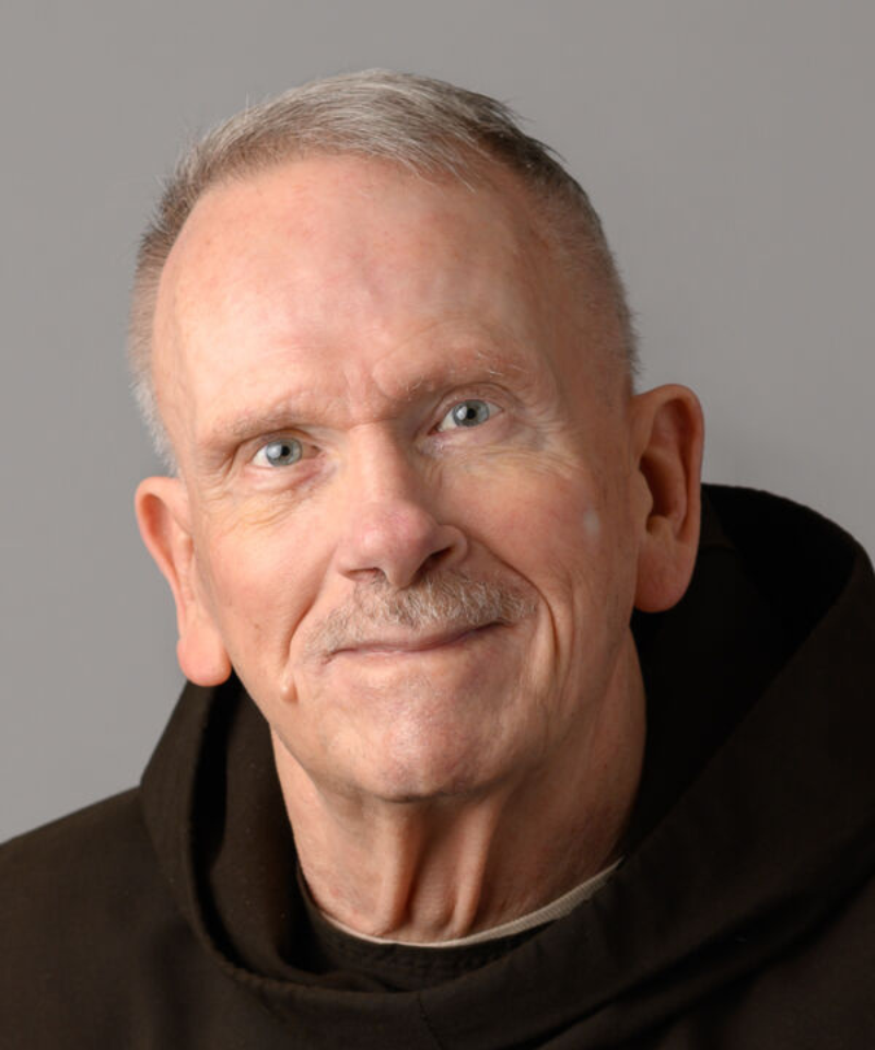 A smiling man wearing a friar habit.