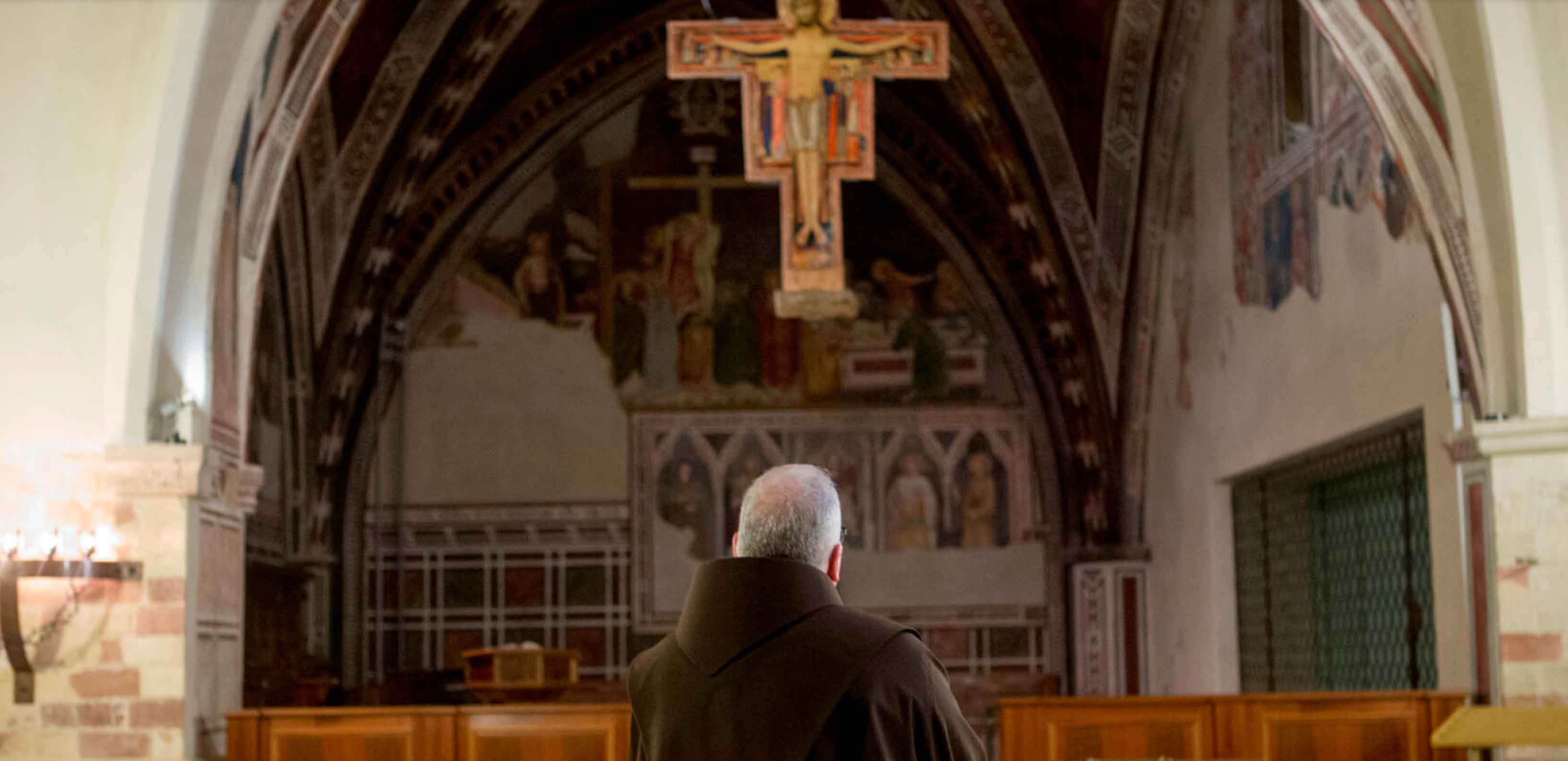 Basil Valente prays before the San Damiano Cross at the Basilica of St. Clare in Assisi