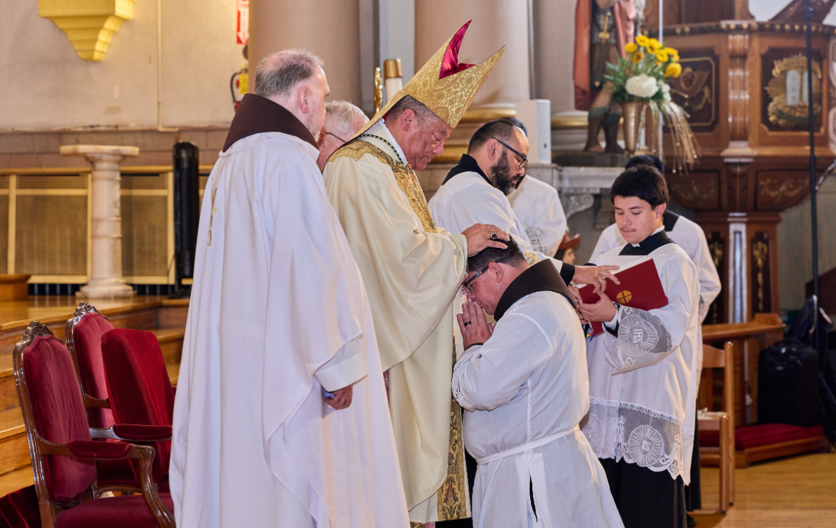 Bishop Perry lays hands on Br. Maikel, a sign of consecration and commissioning. (Photo courtesy of Jesus Martinez)