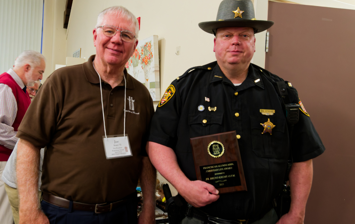 Lieutenant Mikal Steers, right, accepts an award from Joe Sears, FAA Vice President and Awards Chairperson, honoring the late Br. Bruno Kremp, OFM, who served as chaplain with the Hamilton County Sheriff