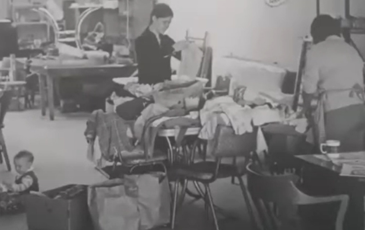 Volunteers sort clothing at the Anawim storefront near the Armitage Street apartments where Gospel Family members lived. The group provided a variety of goods for those in need, including food and clothing. Gospel Family originated with four Franciscan friars from the legacy Assumption Province, who settled into that apartment in October 1969. (Photo courtesy of Br. David Buer, OFM) 
