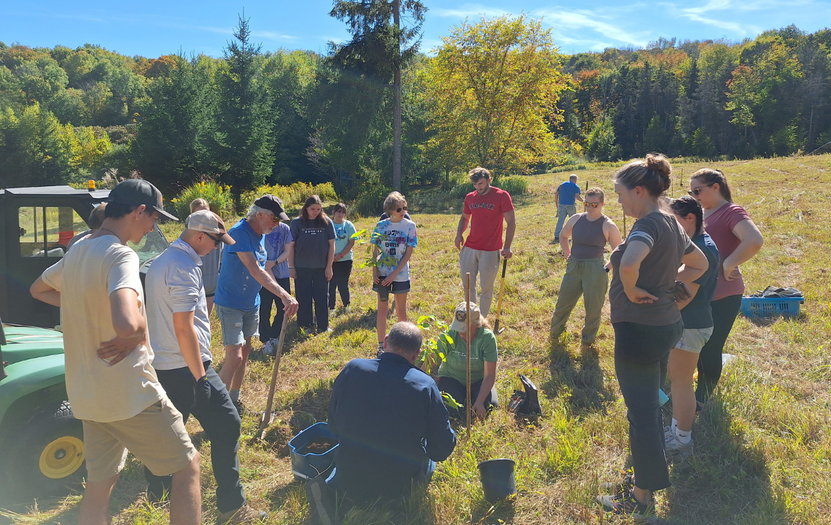 Mike and Rose demonstrate how to plant a tree to students and the Mt. Irenaeus team. (Photo courtesy of Mt. Irenaeus)