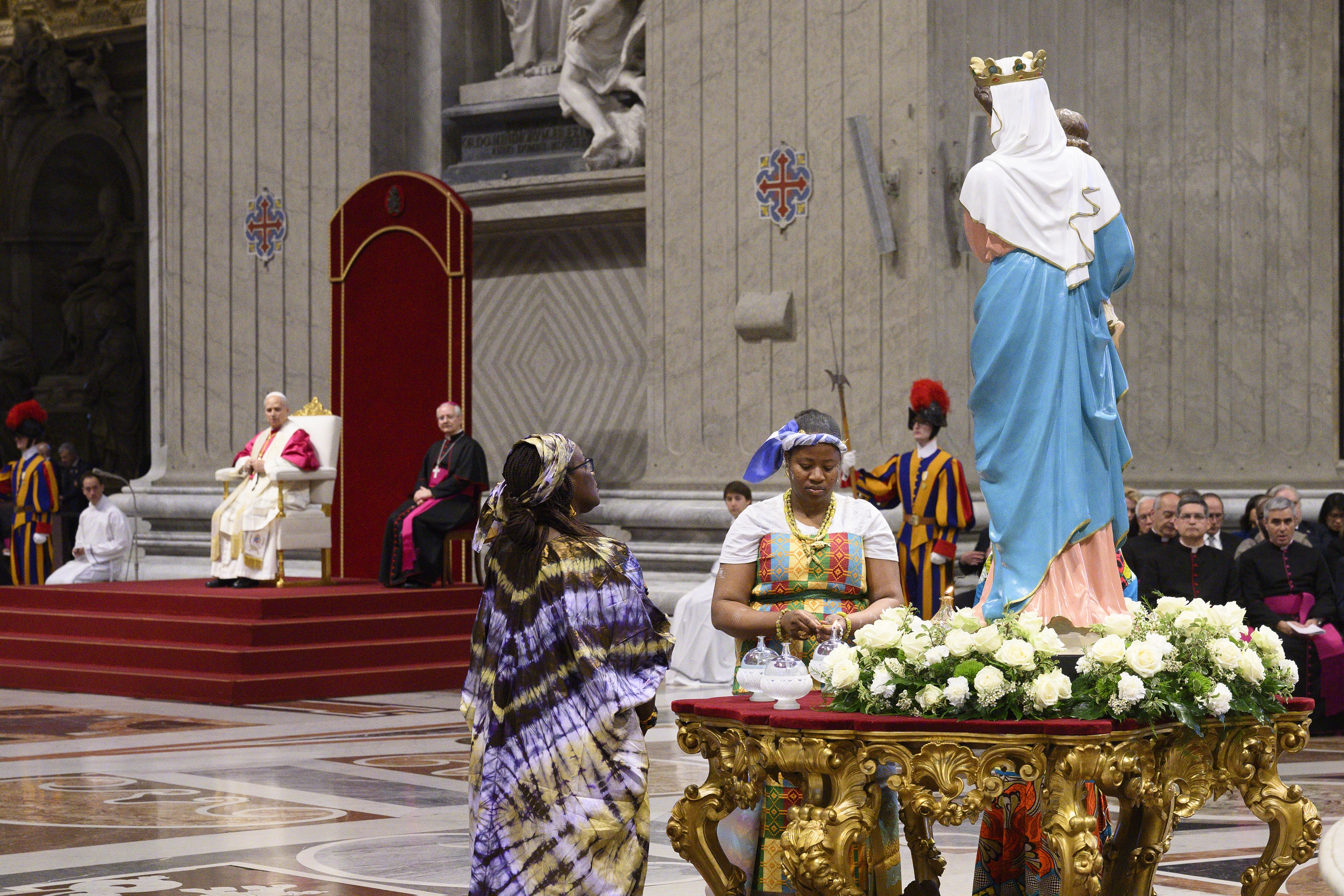 A woman from Africa lights a candle with a flame from the Lamp of Peace, which burns perpetually at the tomb of St. Francis, during a Prayer Vigil for Peace with Pope Leo XIV on April 11. (Photo &copy; Vatican Media)