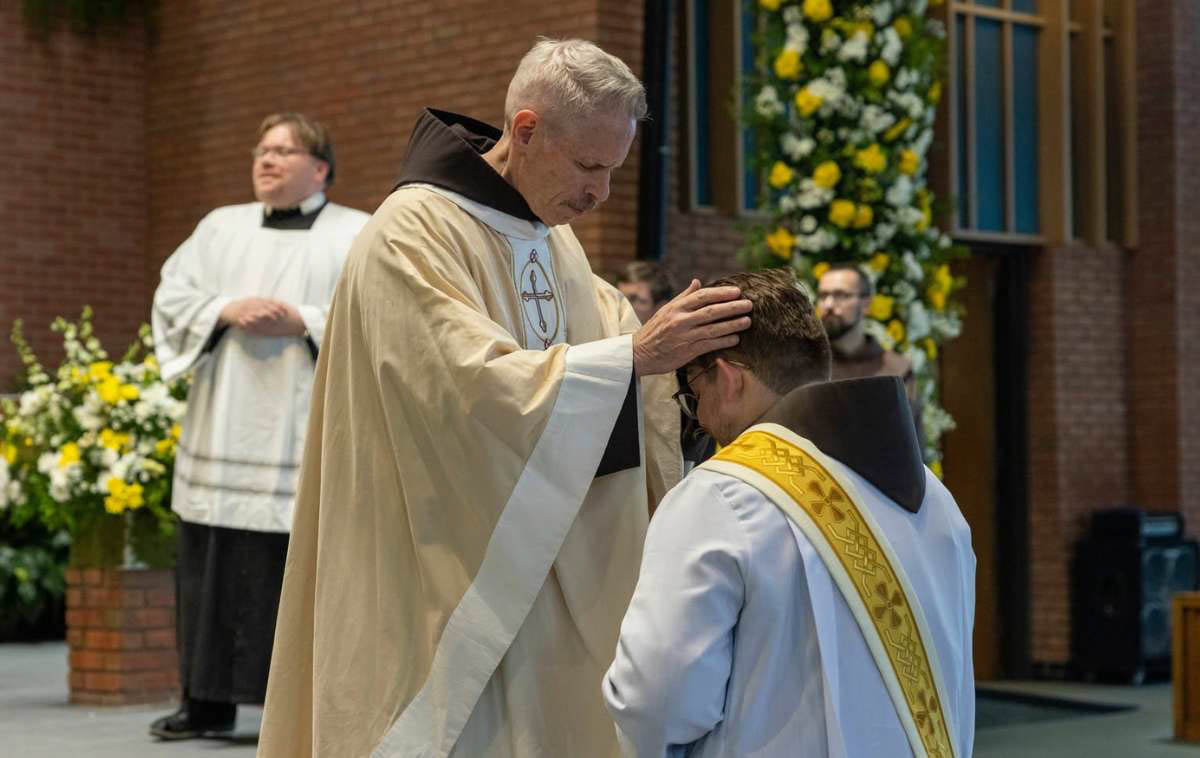 Minister Provincial Br. Michael Perry, OFM, imposes hands over Br. Joshua, the moment the Holy Spirit pours out the graces needed for priesthood. (Photo courtesy of Br. Octavio Duran, OFM)