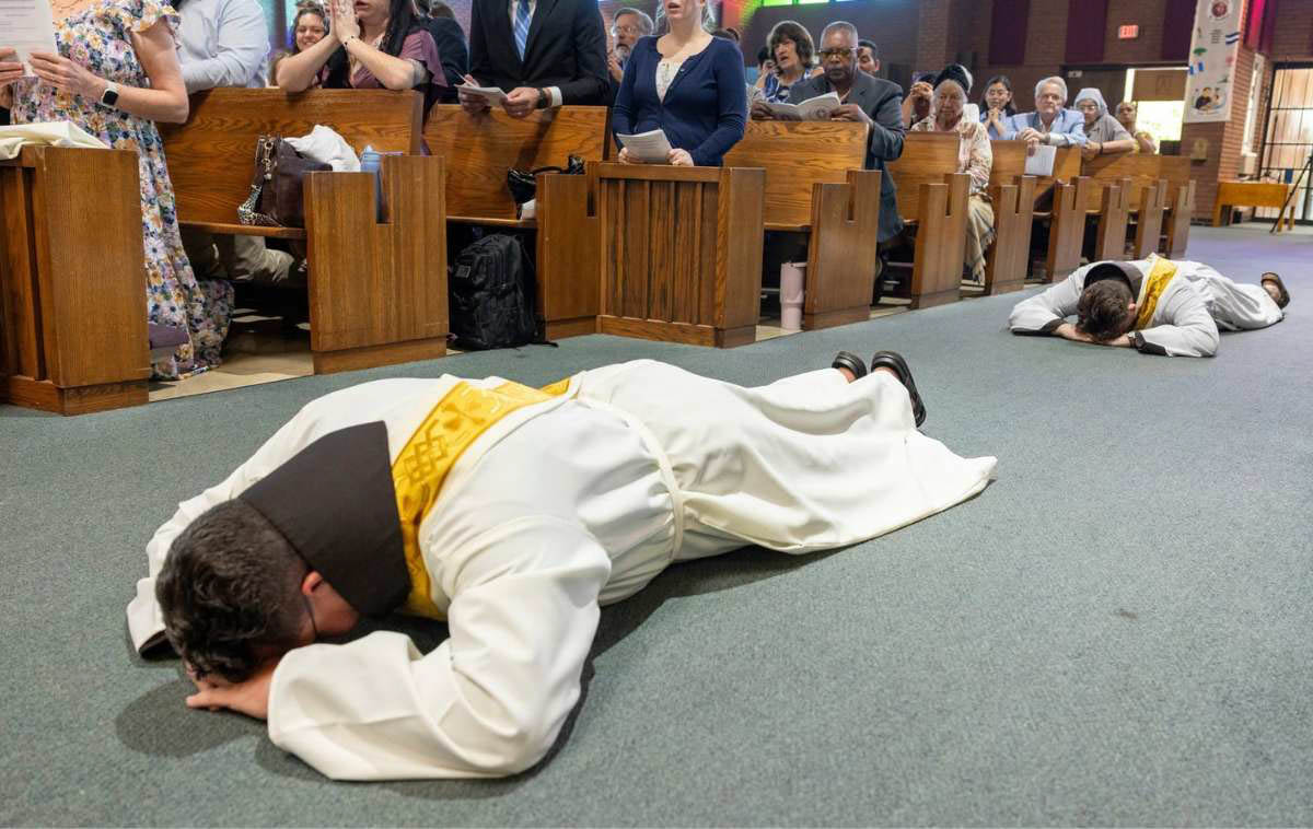Brothers Maikel and Joshua lay prostrate before the altar during the Litany of the Saints as the assembly prays for their intercession. (Photo courtesy of Br. Octavio Duran, OFM)