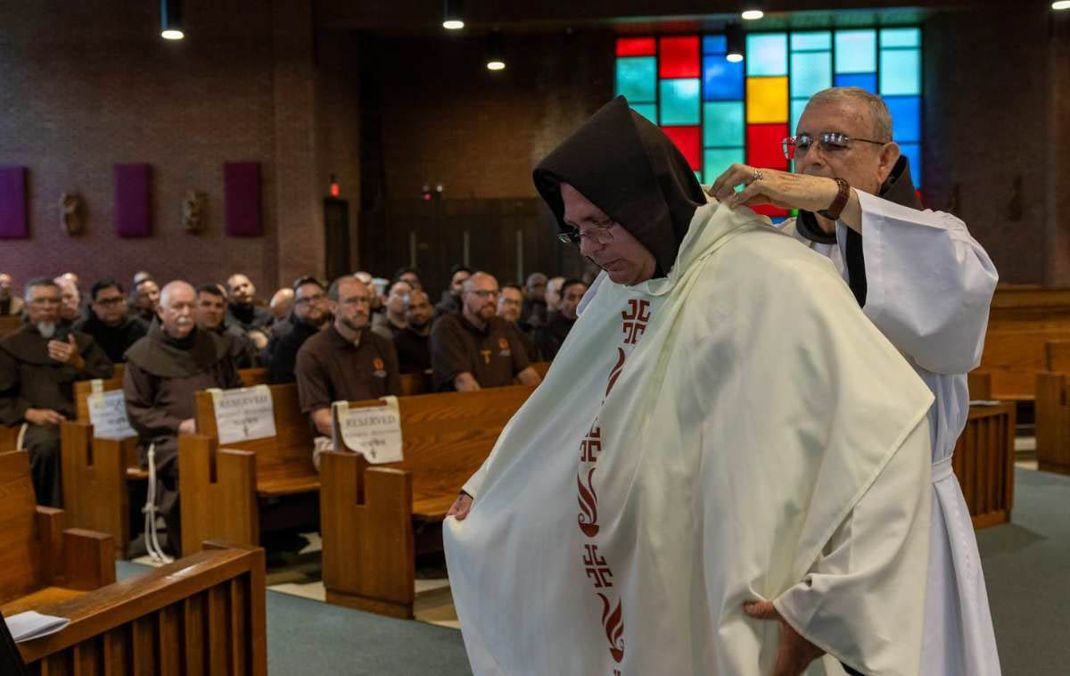The new priests' vestments were carried forward by their loved ones and handed to the friars who assisted them as they donned the stole and chasuble. Here, Br. Jose Santos Perez Castillo, OFM, assists Br. Maikel with his vestments. (Photo courtesy of Br. Octavio Duran, OFM)