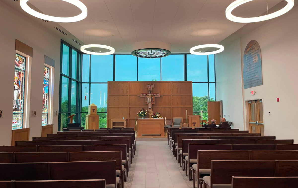 A bronze plaque featuring the Franciscan Blessing and the San Damiano Cross above the chapel's main altar are reminders of the Franciscan spirit that continues to inspire the Roger Bacon community. (Photo courtesy of Michael Rademacher)