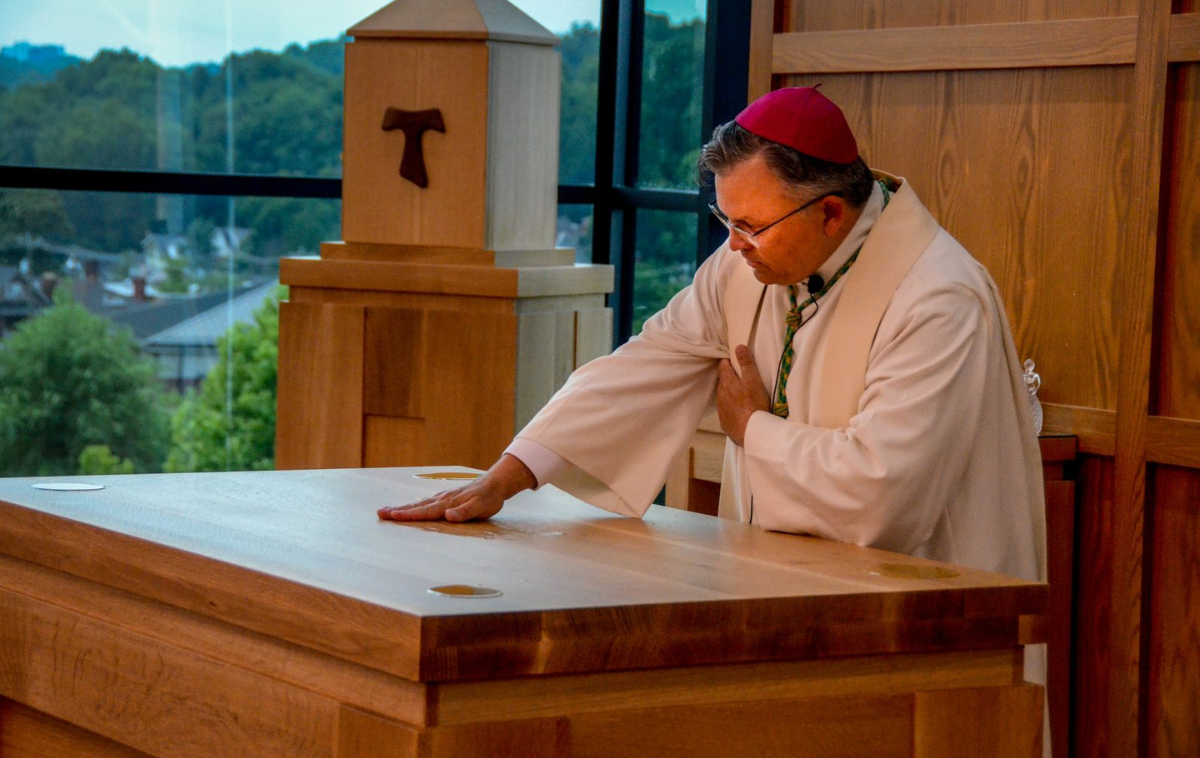Archbishop Robert Casey anoints the new chapel's altar using sacred chrism. (Photo courtesy of Br. Frank Jasper, OFM)