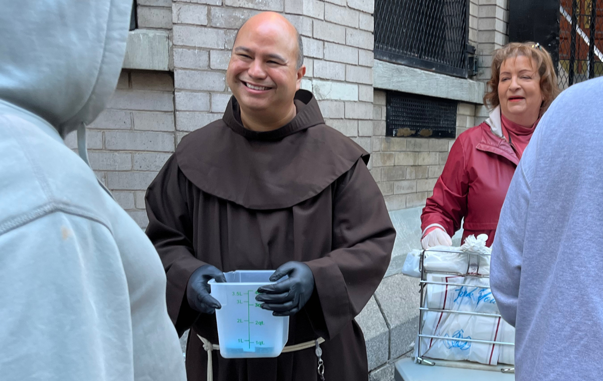 Provincial Councilor Br. Roger Lopez, OFM, greets guests at the St. Francis Breadline in New York. (Photo courtesy of Emily Marcelli, OSF)