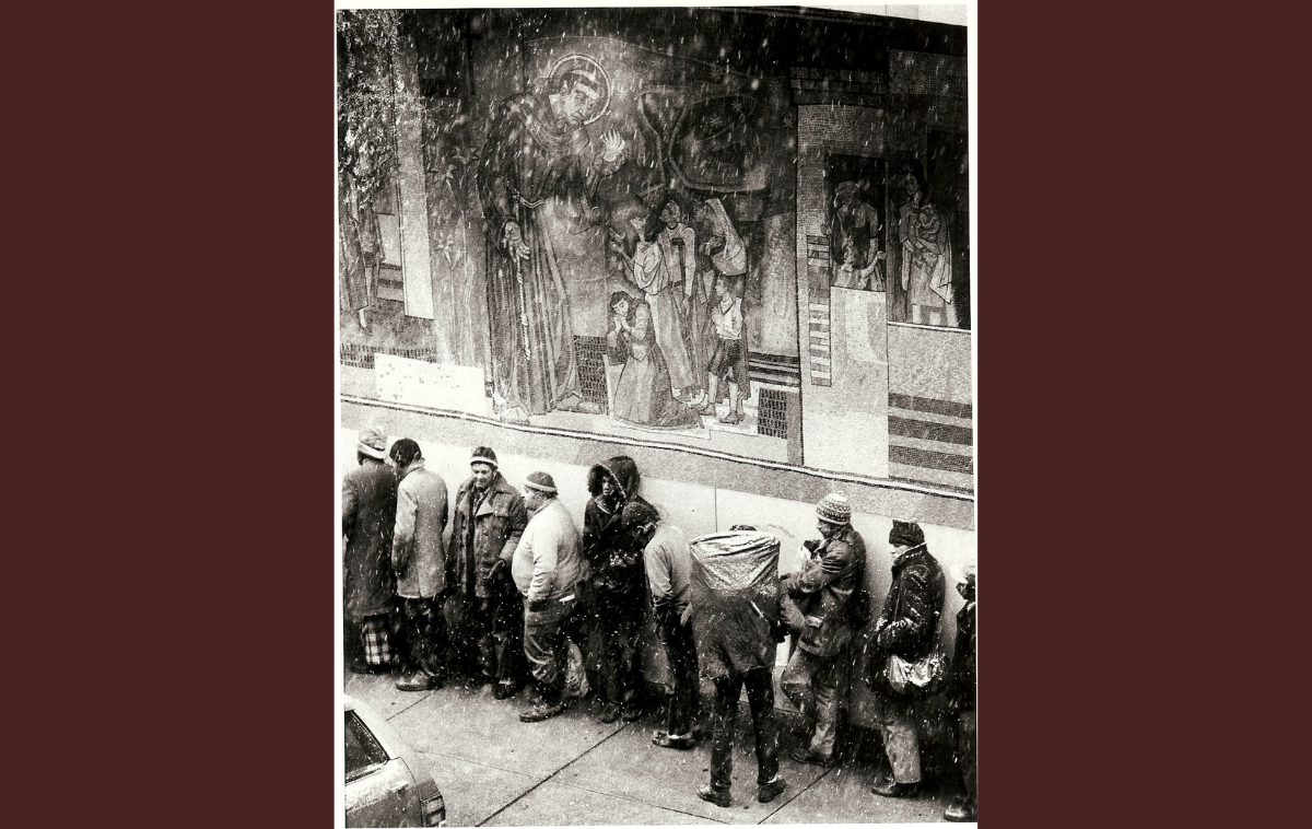 An undated file photo shows people lined up in the snow at St. Francis House in Boston, which supports homeless single adults when few services are available. (St. Francis House photo)