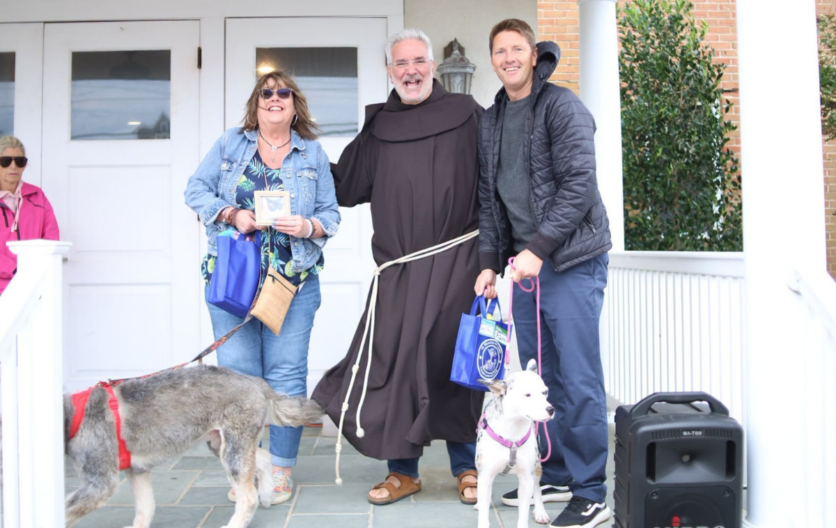 Feast day activities such as the pet blessing were a joy for Br. Francis Di Spigno, OFM, and friends. (Photo courtesy of St. Francis of Assisi Parish)