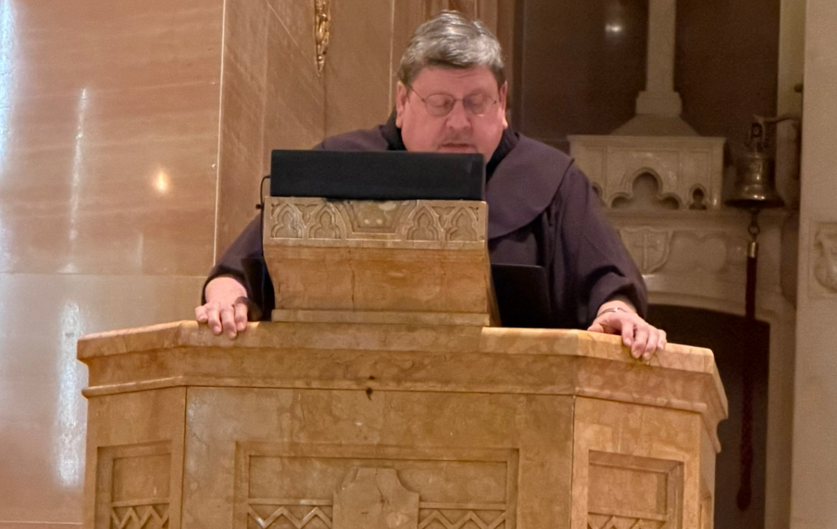 Br. Thom Smith, at the ambo, co-lead the Transitus services. (Photo courtesy of St. Peter’s in the Loop)