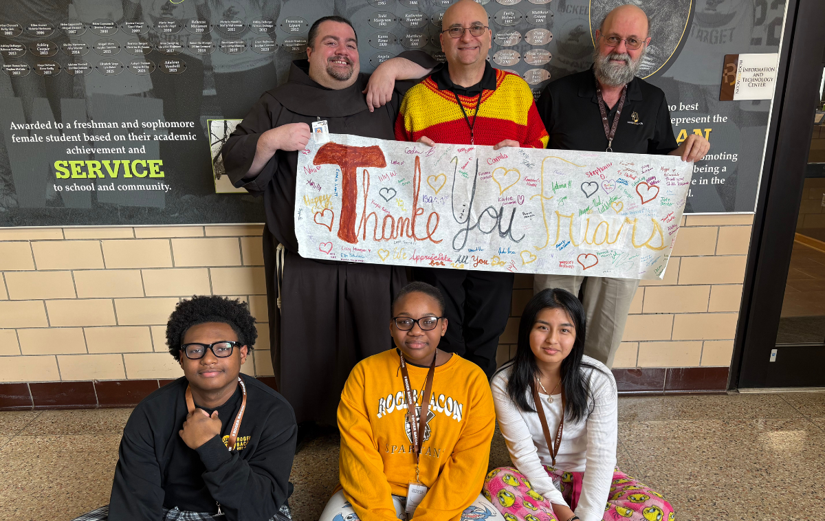 Br. Angel Vázquez, OFM, back row left, with Brothers Mark Hudak, OFM, and Christopher Cahill, OFM, at Roger Bacon High School in Cincinnati, with students. “I’m grateful for taking with me the stories I learned,” Br. Angel said. 