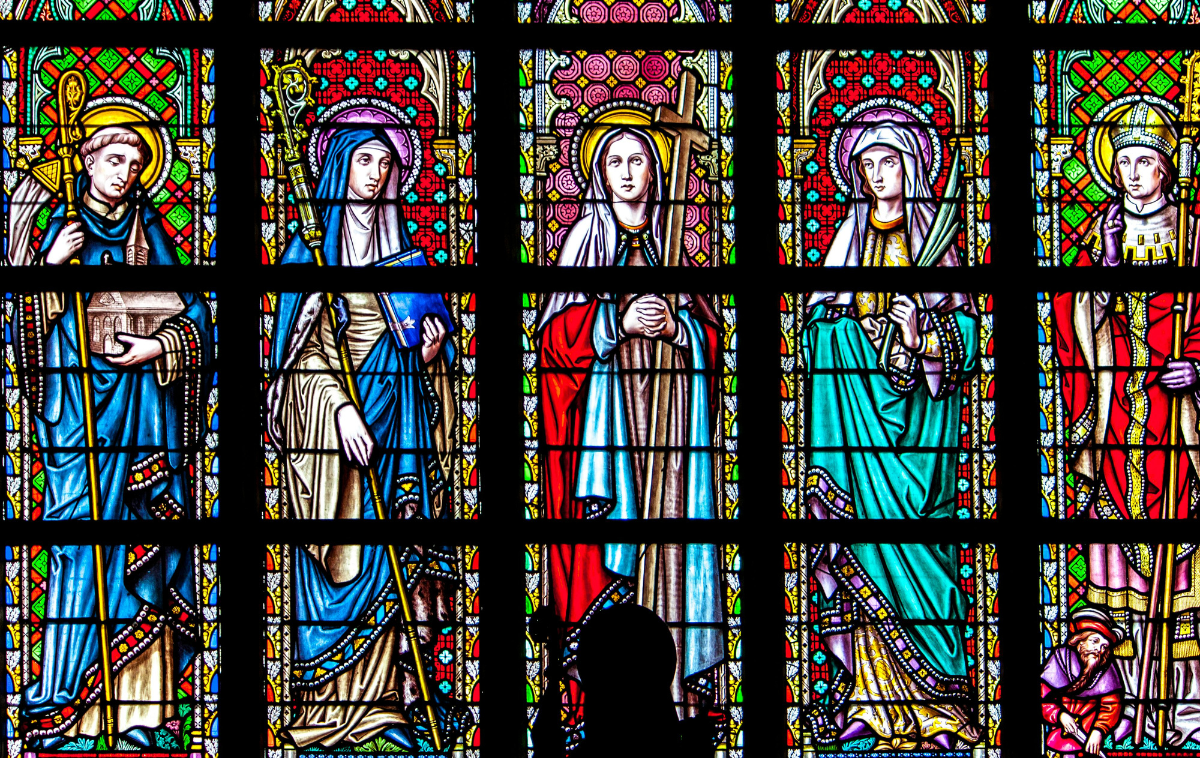 A stained-glass window depicts five saints.